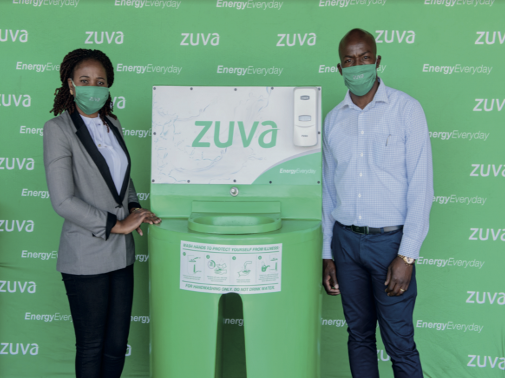 Retail Manager Mrs S Matinya hands over a Hand washing Station to Mr A Shonhiwa Dealer at Zuva Sherwood Service station