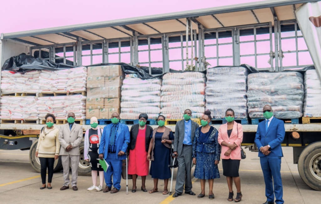 Mr Gumbo and Mr Matorera pose for a picture with some of the representatives from the beneficiary homes.